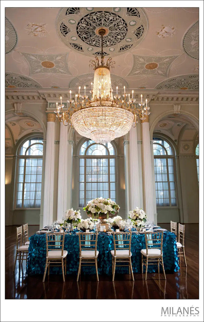 Estate reception table with a full floral runner and candles