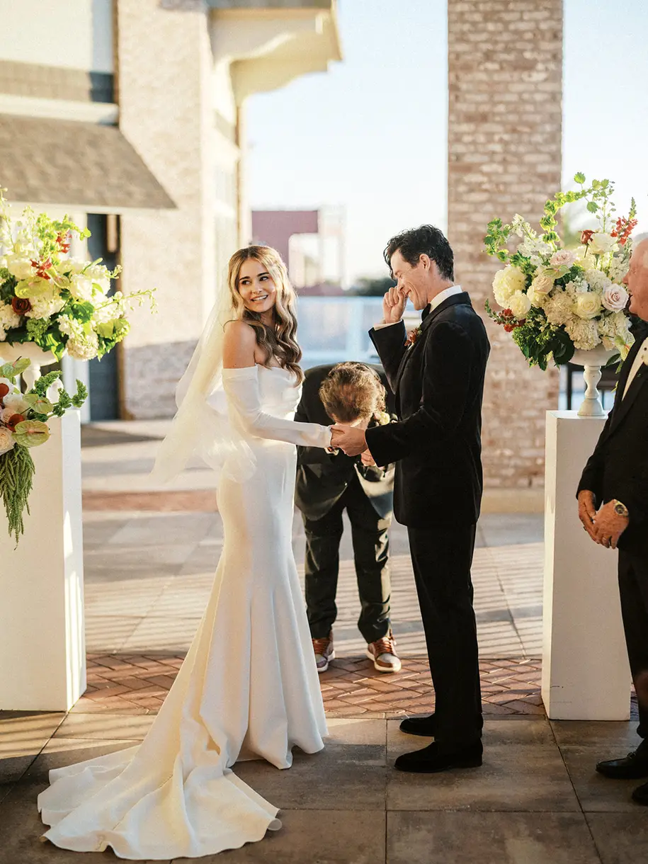 Ceremony 'I do' moment framed by lush wedding florals